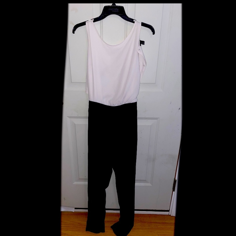 Pantsuit romper with cutout in back and button. Business attire.